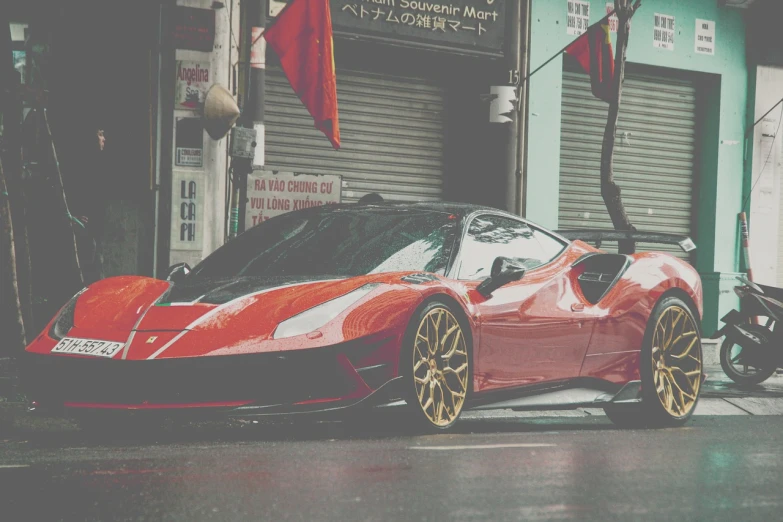 a red sports car parked in front of a building, a picture, tumblr, wet streets, f12, gold and red, veneno