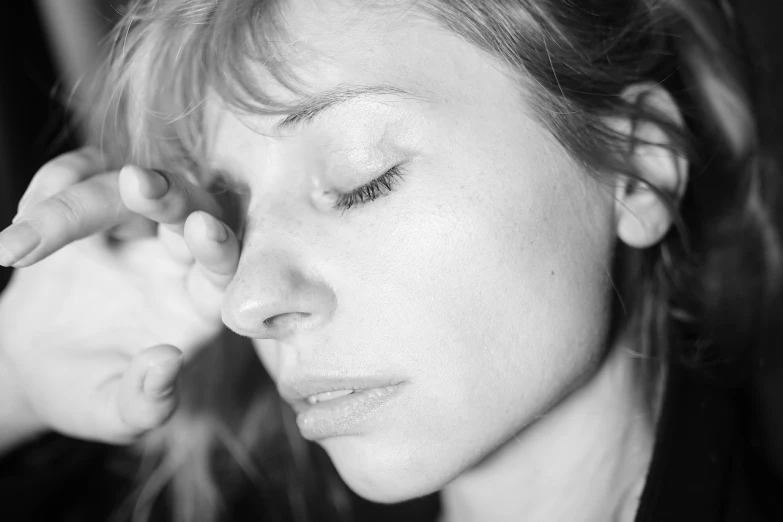 a black and white photo of a woman with her eyes closed, by Michael Sittow, pexels, hyperrealism, light stubble, scar across nose, portrait of mia farrow, photoshoot for skincare brand