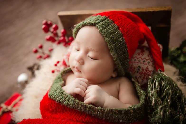 a close up of a baby wearing a knitted hat, inspired by Ernest William Christmas, shutterstock contest winner, fine art, red and green color scheme, sleeping, various posed, cai xukun