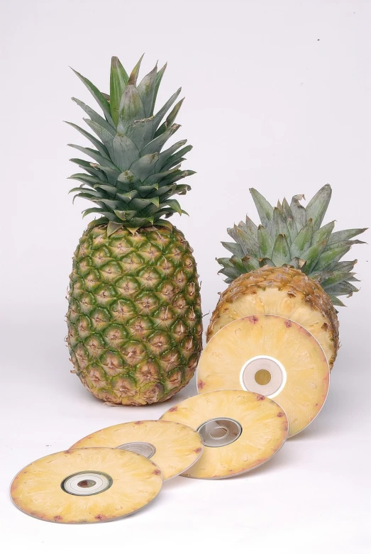 a pineapple cut in half next to a whole pineapple, a picture, by Robert Medley, dvd, pi-slices and kidmograph, product introduction photo, detailed picture