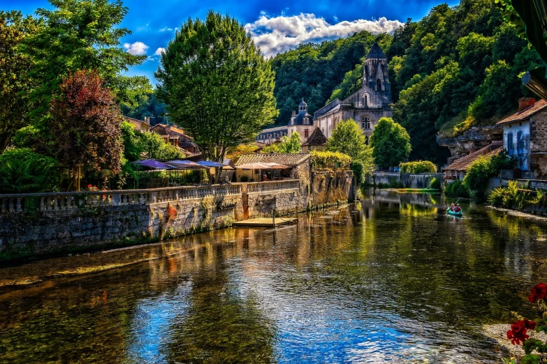 a river running through a lush green forest filled with trees, a picture, by Raphaël Collin, shutterstock, renaissance, french village exterior, layers of colorful reflections, marsden, sunny summer day