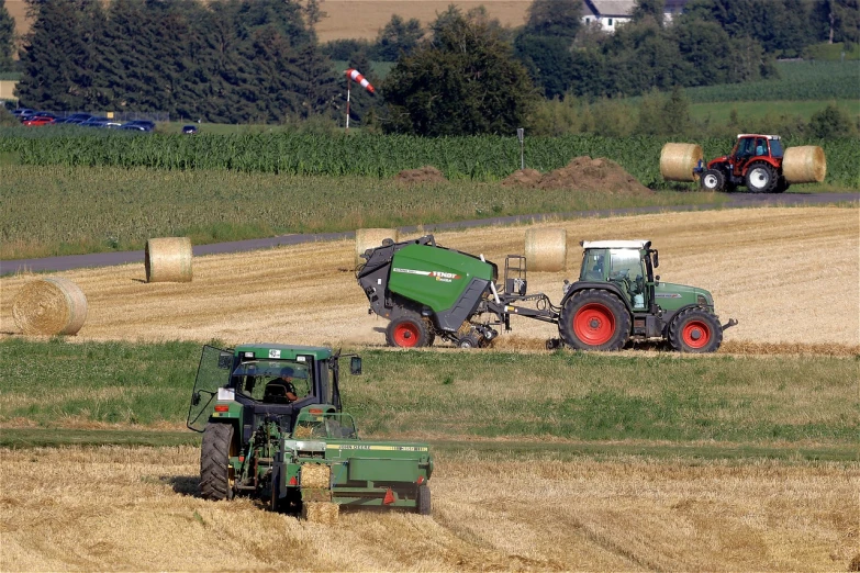 a couple of tractors that are in the grass, a picture, by Hans Schwarz, flickr, figuration libre, field of hay, ball, working out in the field, 2506921471