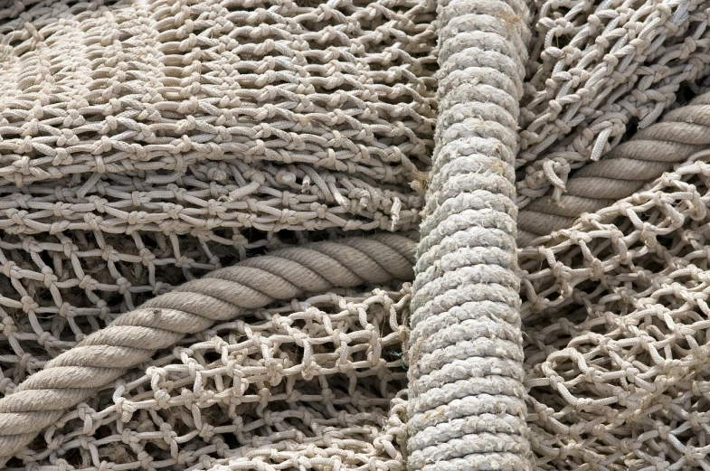 a pile of fishing nets piled on top of each other, high detail photo, subject made of white mesh rope, high details photo