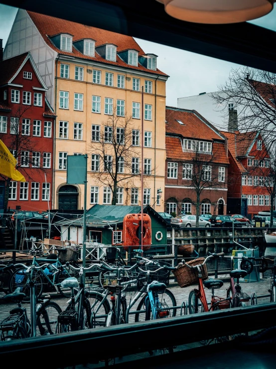 a bunch of bikes parked in front of a building, by Christen Dalsgaard, pexels, view from window, port, stock photo, color photo
