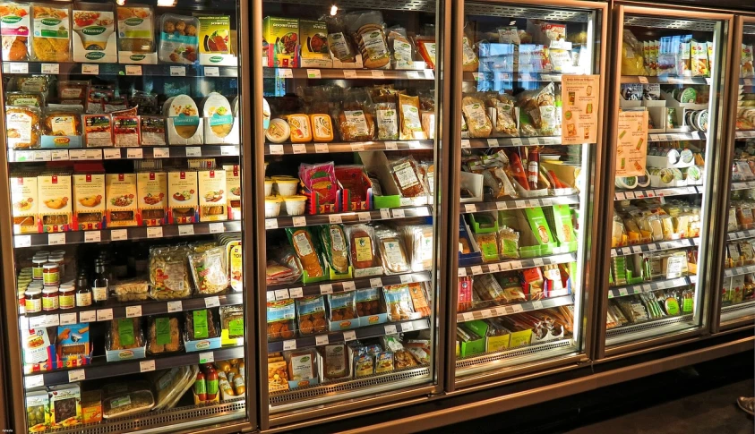 a refrigerator filled with lots of different types of food, a stock photo, by Douglas Shuler, pexels, educational display case, shop front, freezing, unedited