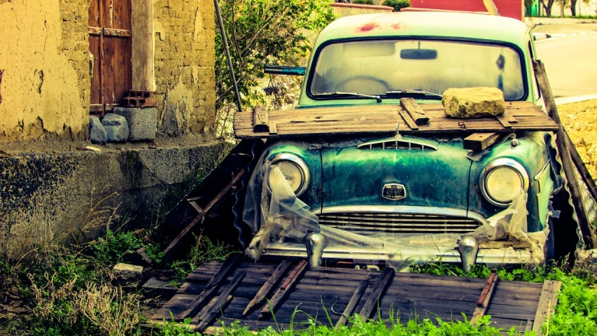 an old green car parked on the side of the road, by Alexander Bogen, pexels contest winner, auto-destructive art, under repairs, wallpaper - 1 0 2 4, old roman style, tools and junk on the ground