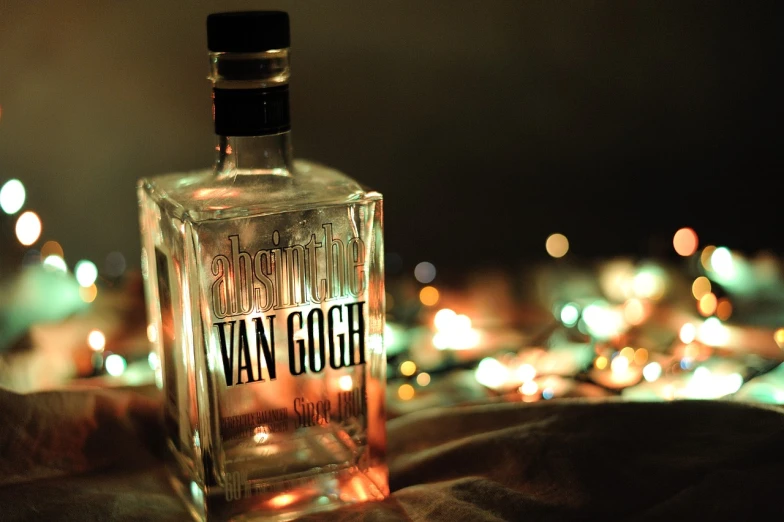 a bottle of vodka sitting on top of a bed, a tilt shift photo, by Hugo van der Goes, tumblr, vanitas, goodnight, shiny skin”, von gogh, cover shot