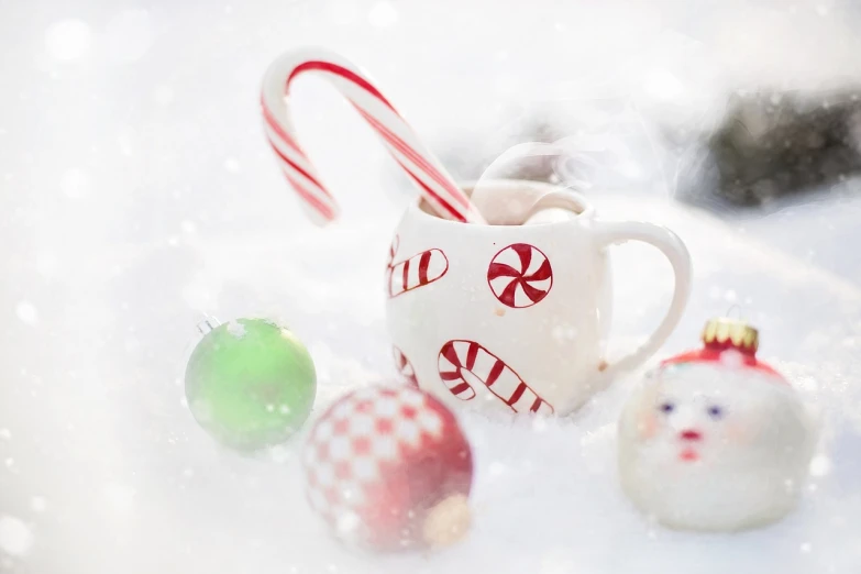 a cup of coffee sitting on top of a snow covered ground, a photo, by January Suchodolski, shutterstock, fine art, candy decorations, santa's workshop, white background”, high quality fantasy stock photo