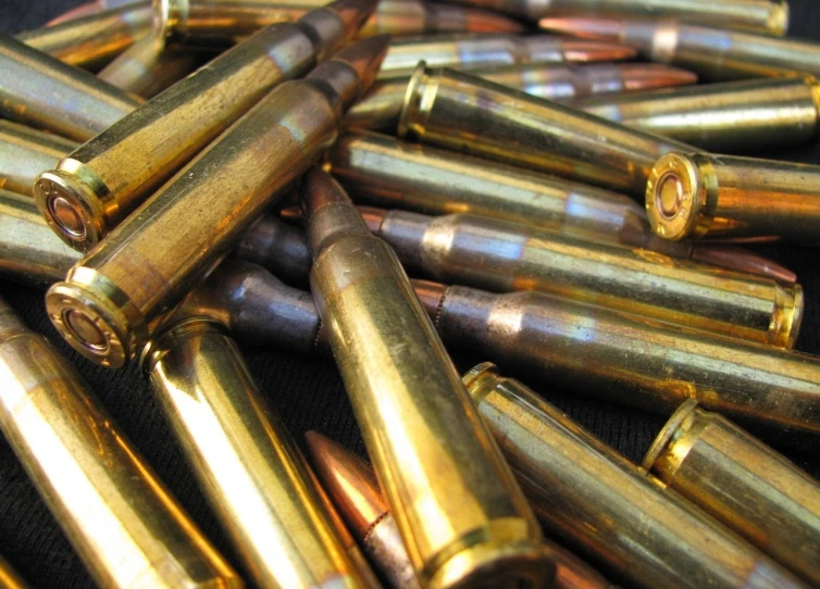 a pile of bullet shells sitting on top of a table, by David Burton-Richardson, flickr, renaissance, detail shot, pulse rifles, band of gold round his breasts, intense knowledge