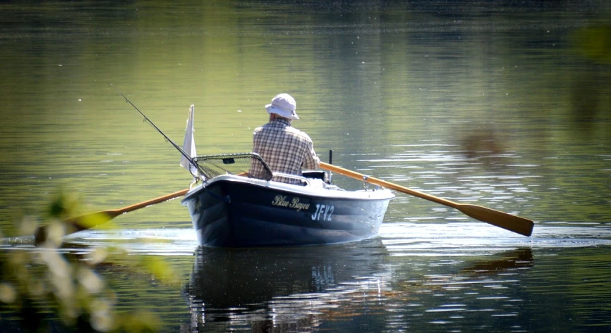 a man in a boat on a body of water, by Alvan Fisher, flickr, fishing pole, loosely cropped, m. c. esher, competition winning