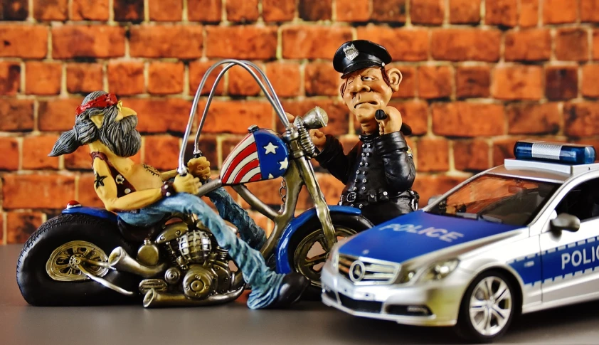 a figurine of a man riding a motorcycle next to a police car, by Arnie Swekel, pixabay, photorealism, uncle sam, portrait of cheech and chong, police tesla, airbrushing