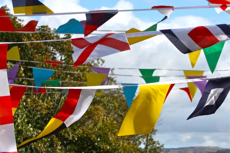 a bunch of flags that are hanging in the air, by David Garner, happening, thisset colours, photo 85mm, tudor, version 3