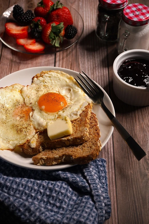 a close up of a plate of food on a table, shutterstock, hearty breakfast, toast, in style of mike savad”, egg