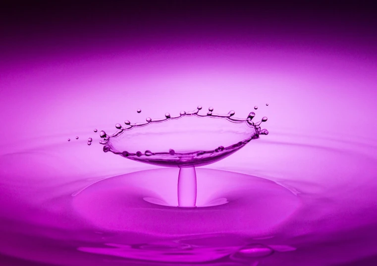 a splash of water on top of a purple surface, a stock photo, by Jan Rustem, minimalism, focus stacking, purple lighting, on display, shot with a canon 20mm lens
