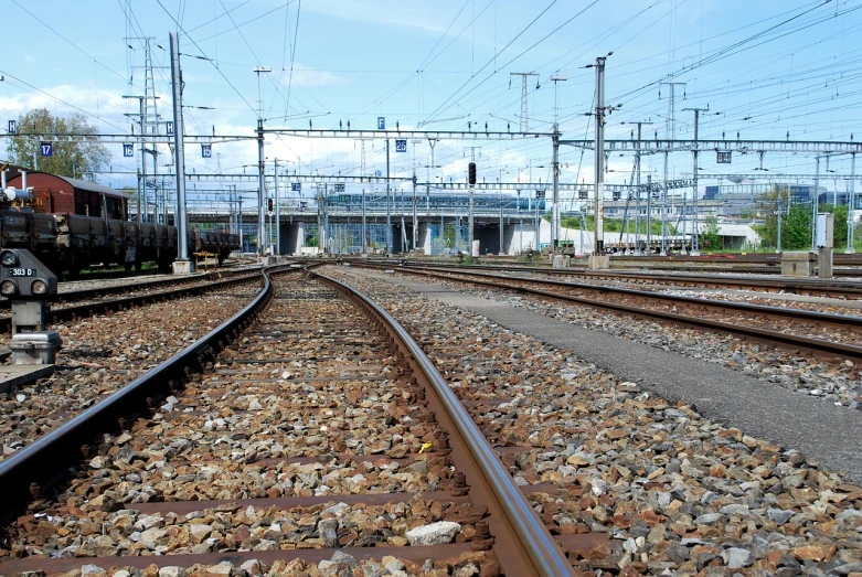 a couple of train tracks sitting next to each other, by Thomas Häfner, flickr, regionalism, train station in summer, cables everywhere, jr sc maglev, maintenance photo