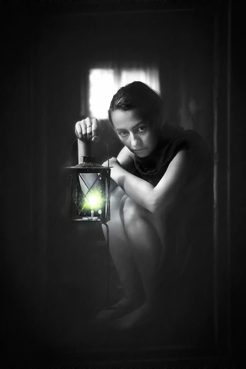 a black and white photo of a woman holding a lantern, a picture, pixabay, art photography, green glow, cute boy, worried, olga buzova