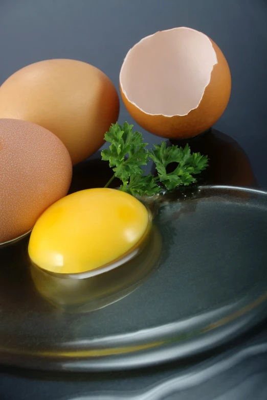 a group of eggs sitting on top of a black plate, a still life, close-up product photo, istockphoto, on a reflective gold plate, product introduction photo