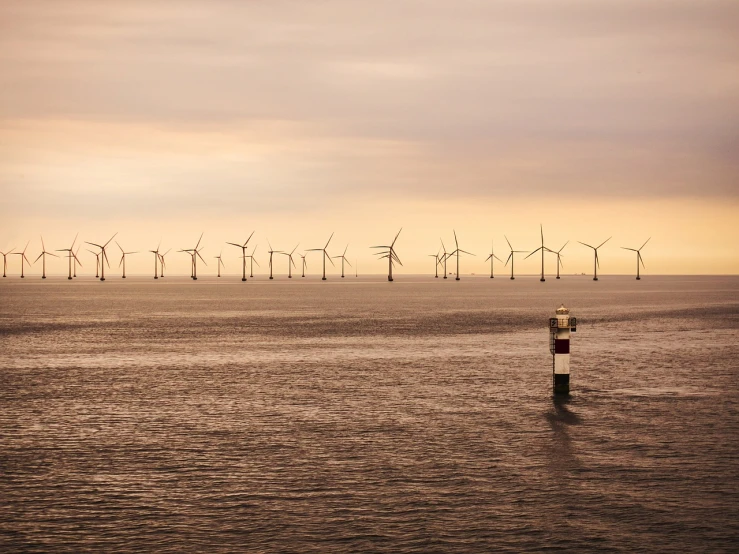 a large body of water with wind turbines in the background, a picture, by John Murdoch, pexels, horizon forbideen west, tubes, highfleet, rhythm of the wind