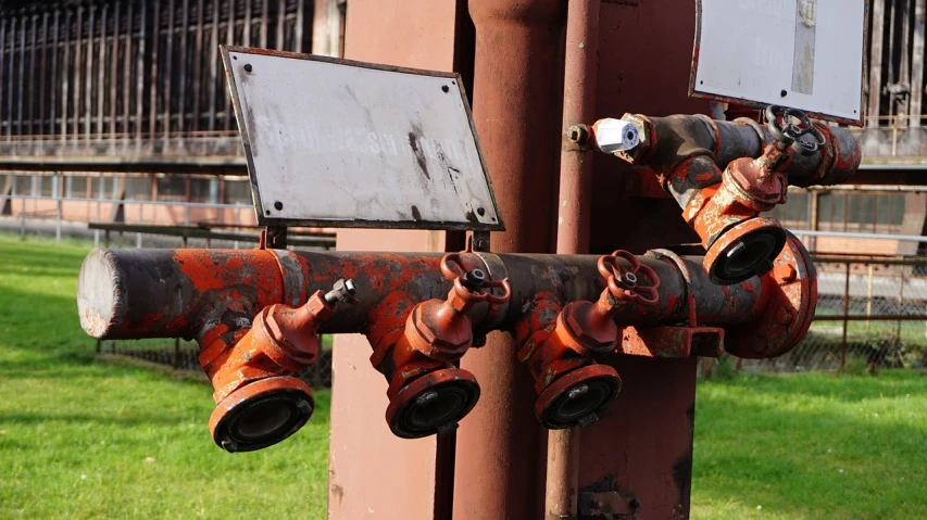 a close up of a fire hydrant on a pole, a photo, graffiti, industrial light magic, empty eye sockets, industrial machinery, drip