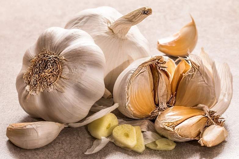 a bunch of garlic sitting on top of a table, a macro photograph, shutterstock, grey vegetables, high detail product photo, white-haired, close-up product photo