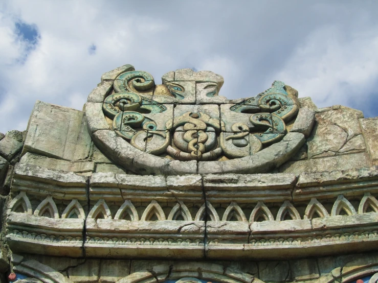 a clock that is on the side of a building, an art deco sculpture, inspired by Rudolf Ernst, flickr, art nouveau, celtic vegetation, stone roof, high texture detail, undersea temple with fish