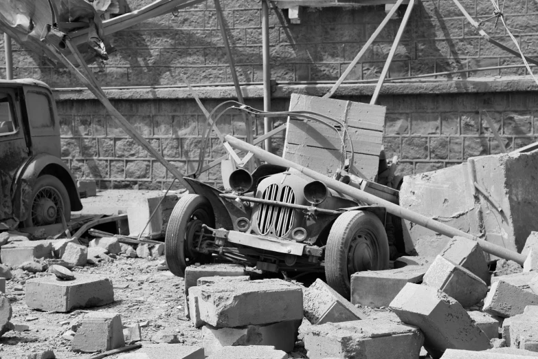 a black and white photo of a wrecked car, by Albert Keller, flickr, crumbling masonry, jeep, under construction, detail on scene