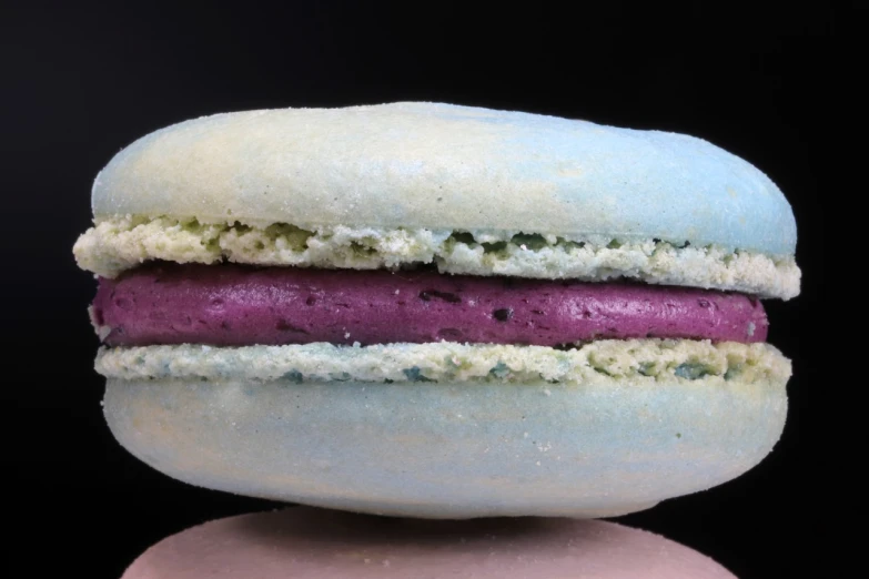 a blue and pink macaron sitting on top of a table, inspired by Joris van der Haagen, profile close-up view, thumbnail, with celadon glaze, violet polsangi