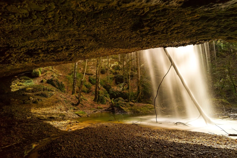 a waterfall coming out of a cave in the woods, by Thomas Häfner, urban exploring, backlit!!, sweeping arches, - - ar 9 : 1 6