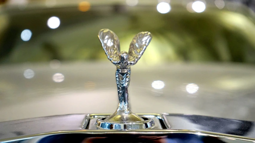 a close up of a car hood ornament, an art deco sculpture, by Roger Cecil, unsplash, in style of chrome hearts, inside view, triumphant pose, made of crystal