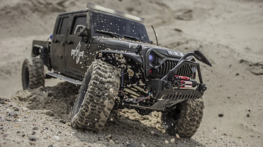 a jeep that is sitting in the sand, by Jason Felix, tumblr, scale model photography, high quality action photography, intense sunlight, modded