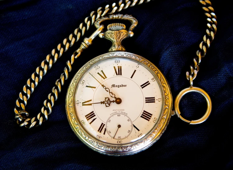 a close up of a pocket watch with a chain, a photo, art nouveau, silver and gold, navy, professional unique master piece, miscellaneous objects