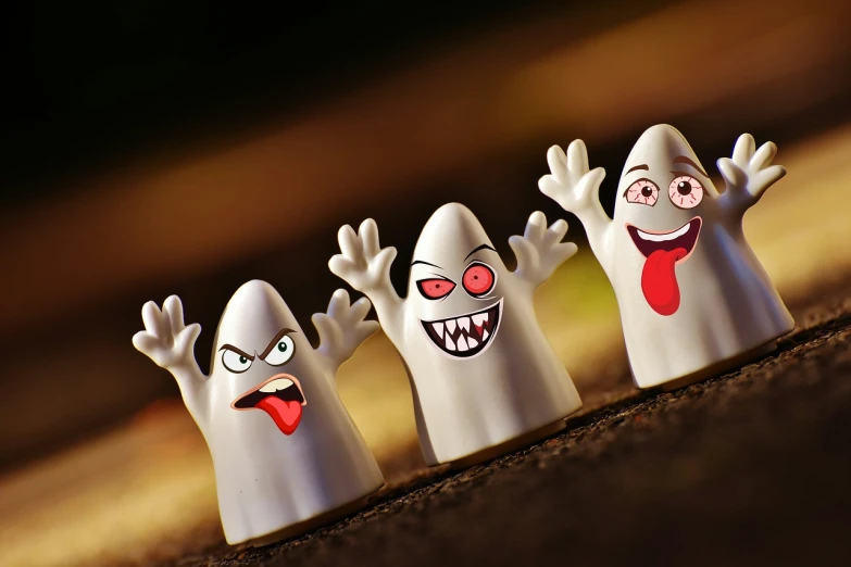 a group of ghost figurines sitting on top of a table, a picture, shock art, cute teeth, toony, ad image, finger