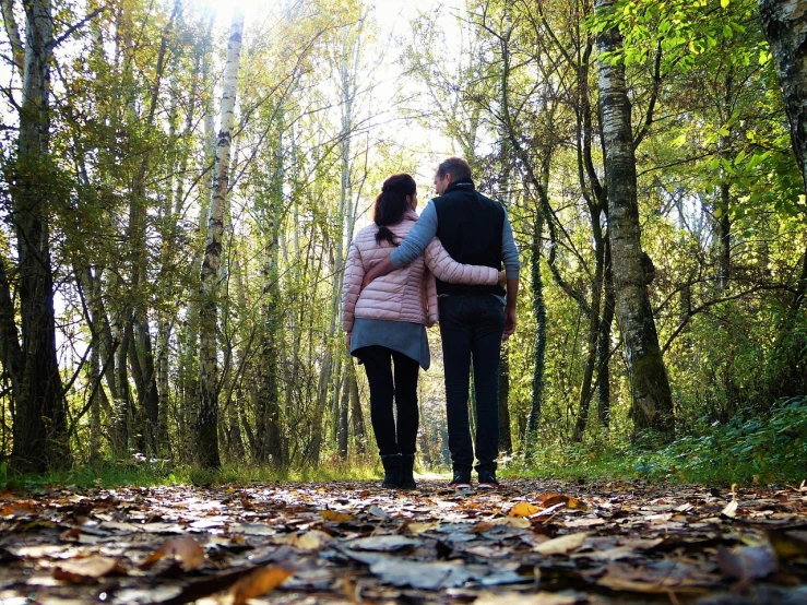 a couple of people that are walking in the woods, a picture, by Maksimilijan Vanka, pixabay, embracing, stock footage, october, family friendly