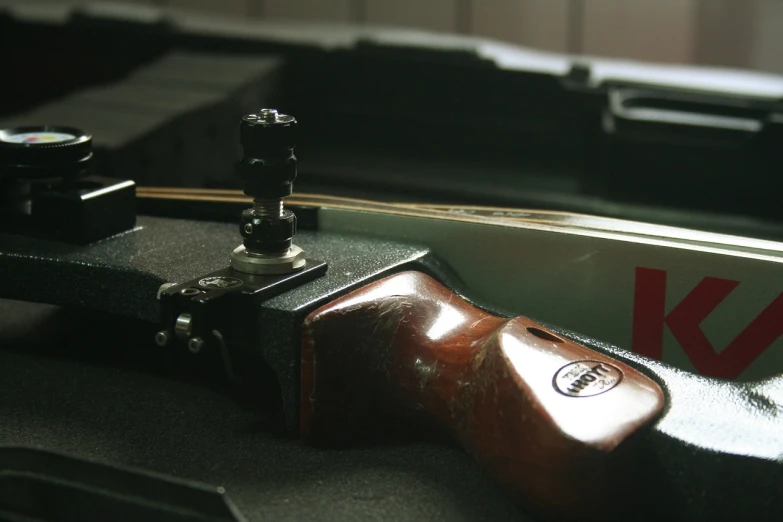 a close up of a guitar in a case, a picture, by Jakob Gauermann, flickr, heroic shooting bow pose, target reticles, woodlathe, air shot