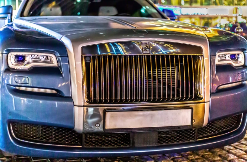 a blue rolls royce parked on a cobblestone street, a stock photo, by Andrei Kolkoutine, shutterstock, renaissance, hdr detail, night life, straight smooth vertical, gold and steel intricate