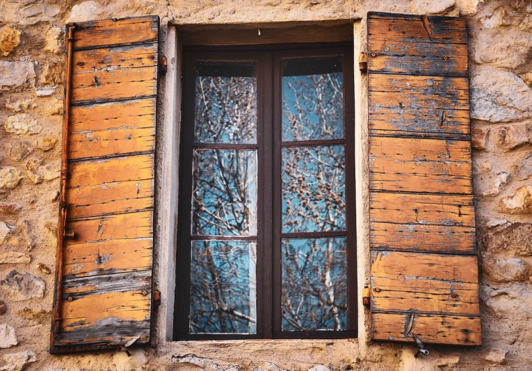 a close up of a window with wooden shutters, a picture, by Matthias Weischer, shutterstock, broken panes of glass, dormant nature, massive trees with warm windows, ocher and turquoise colors