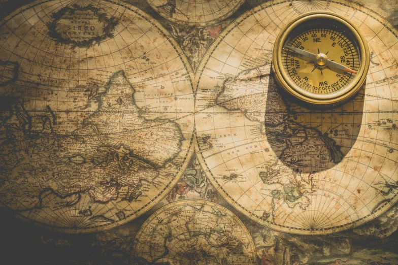a compass sitting on top of a map, a portrait, pexels, baroque, aerial view of an ancient land, mercator projection, captain, worlds collide