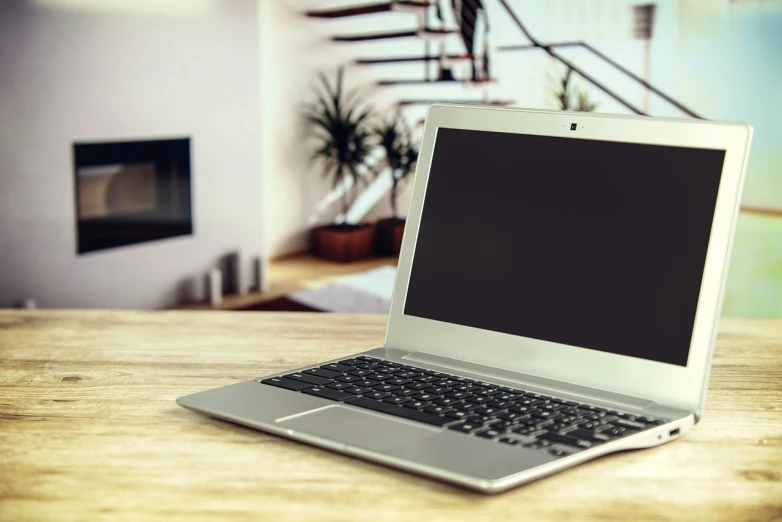 a laptop computer sitting on top of a wooden table, shutterstock, modern very sharp photo, living room background, half body photo, stock photo