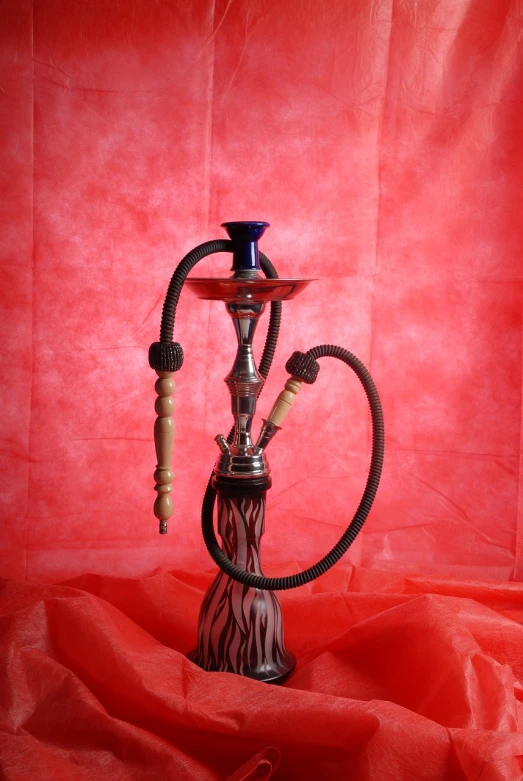 a hook sitting on top of a red cloth, an airbrush painting, inspired by Aladár Körösfői-Kriesch, shutterstock, arabesque, glass pipes showing red, high quality fantasy stock photo, full body shot, with a straw