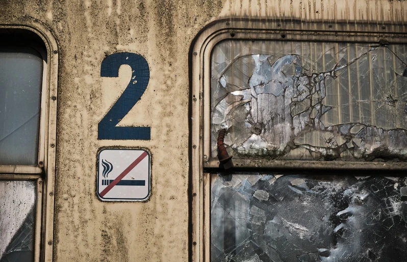 a no smoking sign on the side of a train, a portrait, by Richard Carline, decay texture, broken windows, year 2 0 2 2, two hang