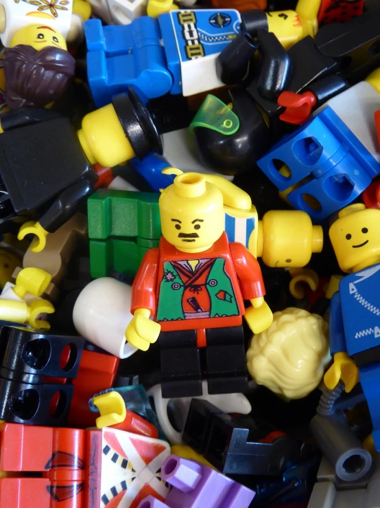 a pile of legos sitting on top of a table, a picture, by Jason Felix, single character, colourful clothing, ebay photo, broadshouldered