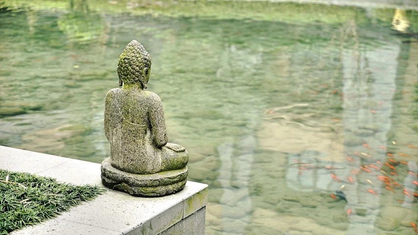 a statue sitting on top of a stone block next to a pond, pixabay, minimalism, in a temple, shallow depth, green water, facing away from the camera