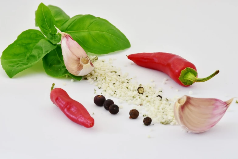 a variety of spices and herbs on a white surface, a photo, by Jan Zrzavý, pexels, renaissance, fresh basil, garlic on background, red and white colors, pepper no. 3 5