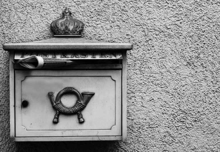 a black and white photo of a mail box, a black and white photo, by Matthias Weischer, symmetrical crown, small details, embossed, coronation