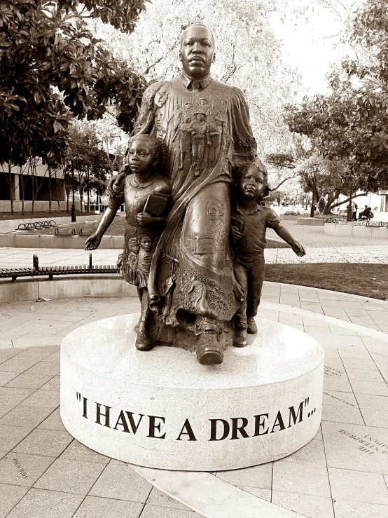 a black and white photo of a statue in a park, a statue, inspired by Eleanor Layfield Davis, happening, !dream los angeles, mother theresa, photo illustration, you may say i'm a dreamer
