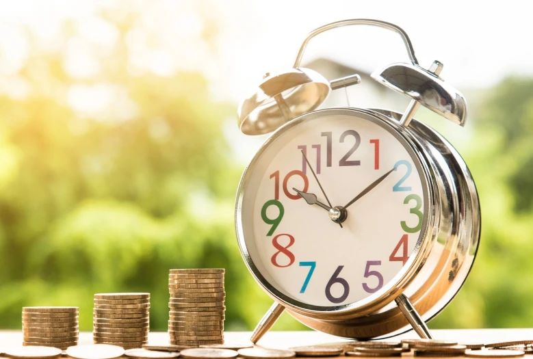 a clock sitting on top of a pile of coins, a stock photo, shutterstock, golden hour closeup photo, high res photo, numerical, springtime morning