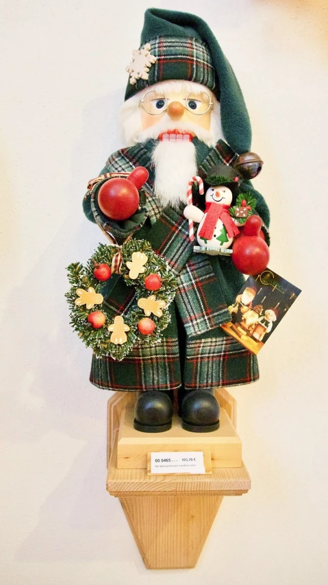 a close up of a figurine of a santa claus, a photo, inspired by Rudolph F. Ingerle, folk art, on a pedestal, dressed in laurel wreath, tartan garment, wooden decoration