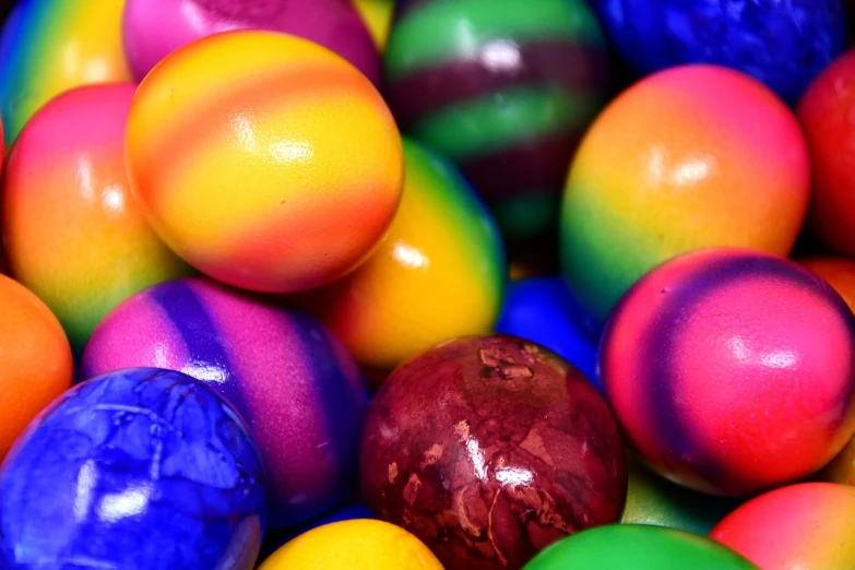 a pile of colorful easter eggs sitting on top of each other, a picture, by Joe Bowler, colorfully background, rainbow sheen, close up photo, rich bright sunny colors