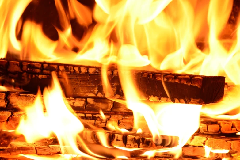 a close up of a fire burning in a fireplace, a picture, shutterstock, fine art, background image, wooden, print, triumphant