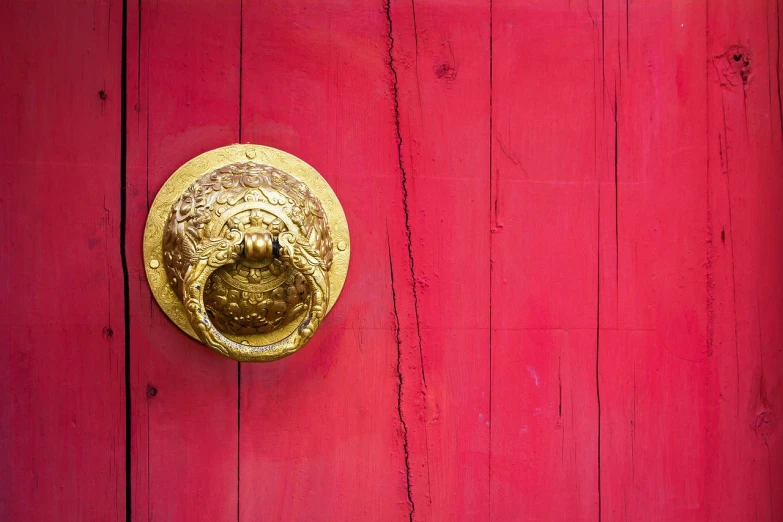 a close up of a door handle on a red door, a stock photo, pexels, cloisonnism, pink and gold, taoist temples and monks, golden cracks, istockphoto